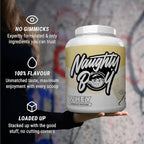 Naughty Boy Advanced Whey-proteinpulverburk i handen med gul etikett och svart logga